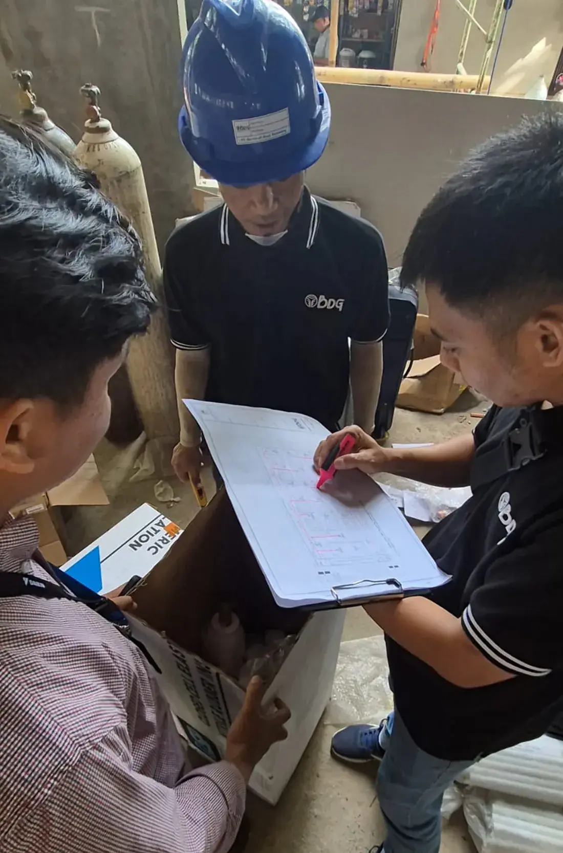 Tim BDG memeriksa gambar kerja di lokasi proyek